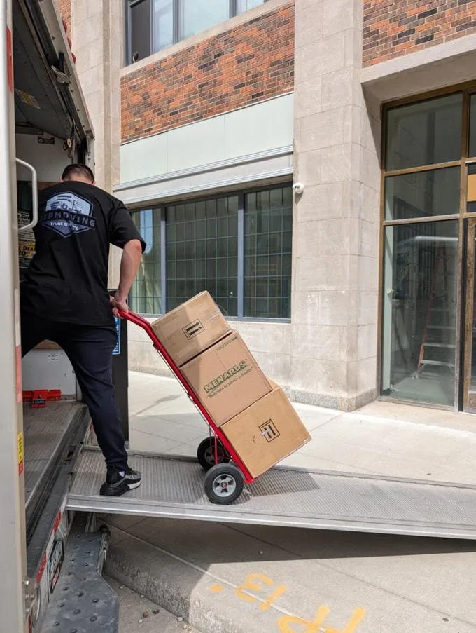 ZIP Moving crew member loading boxes into a moving truck