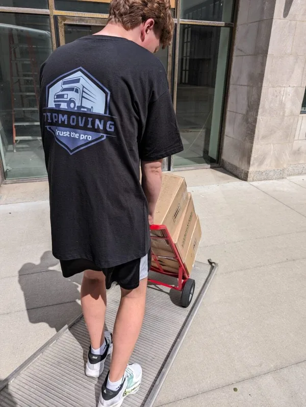 ZIP Moving crew member moving boxes on a hand truck